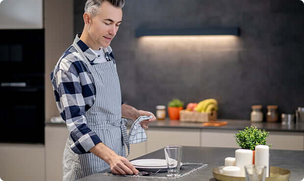 Man cooking on a hob in the kitchen